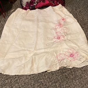 Off white skirt with flower stitching.